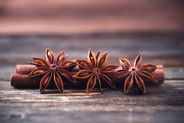 Close up of star anise and cinnamon stick on wooden background