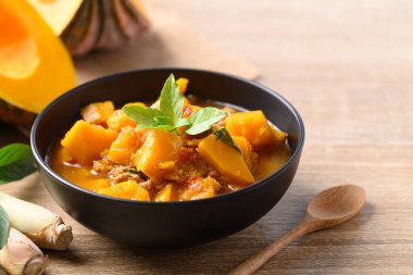 Tahta masada domuz etli baharatlı balkabağı çorbası.