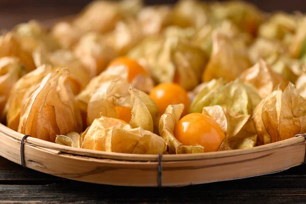 Cape gooseberry or golden berry (Physalis peruviana) in bamboo basket on wooden, Healthy tropical fruit