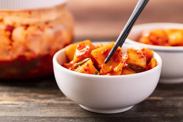 Kimchi radish eating by chopsticks, Korean homemade side dish food