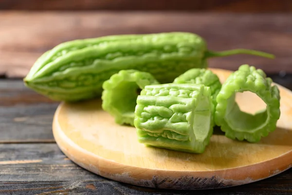 Bitter melon or bitter gourd on wooden board for cooking