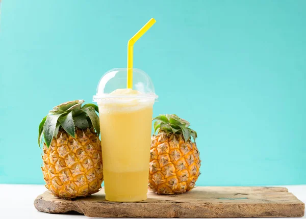 Pineapple smoothie and fresh pineapple fruit on color background, Summer drink