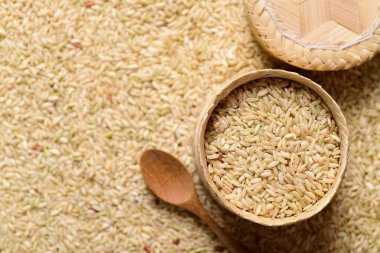 Thai brown rice seeds in bamboo basket, Organic rice, top view