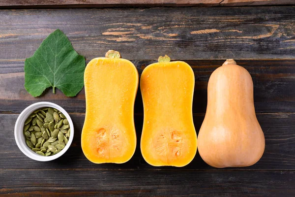 Butternut squash or butternut pumpkin and seed on wooden background, Table top view