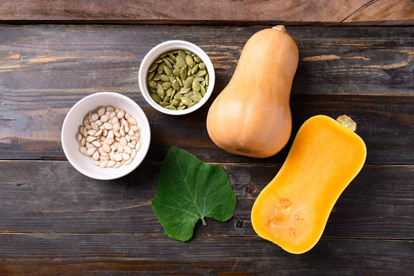 Butternut squash or butternut pumpkin and seed on wooden background, Table top view