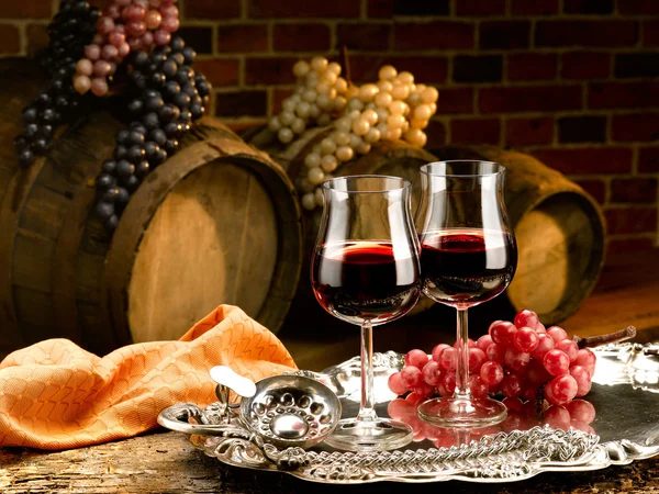 Glasses of red wine in wine cellar — Stock Photo, Image