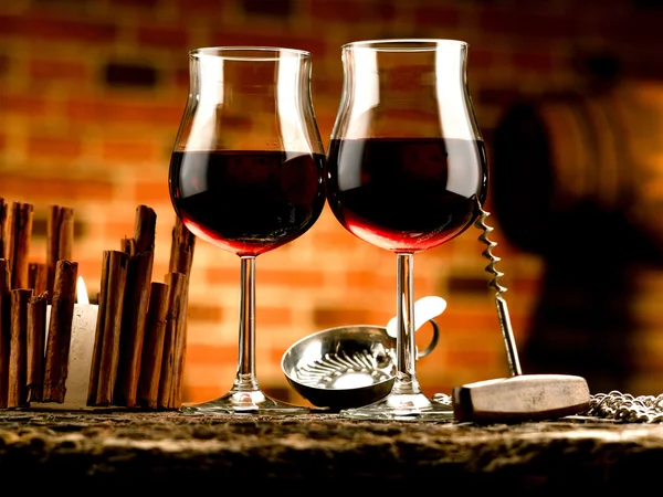 Glasses of red wine in wine cellar — Stock Photo, Image