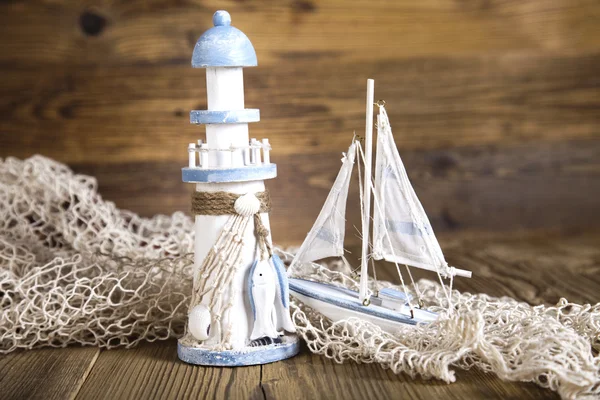 Ship and lighthouse, network with shells — Stock Photo, Image