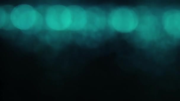 蓝色的绿色抽象背景 在黑暗 无缝的环路背景上 有分散焦点的明亮破碎的灯光 — 图库视频影像