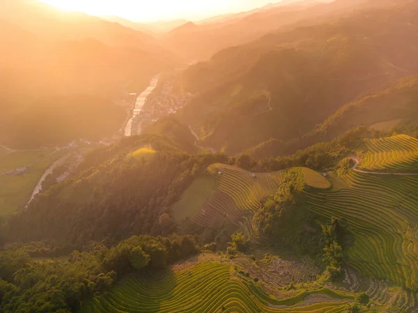 Aerial view of golden rice terraces at Mu cang chai town near Sapa city, north of Vietnam. Beautiful terraced rice field in harvest season in Yen Bai, Vietnam. Travel and landscape concept. Selective focus