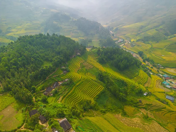 Aerial view of golden rice terraces at Mu cang chai town near Sapa city, north of Vietnam. Beautiful terraced rice field in harvest season in Yen Bai, Vietnam. Travel and landscape concept. Selective focus