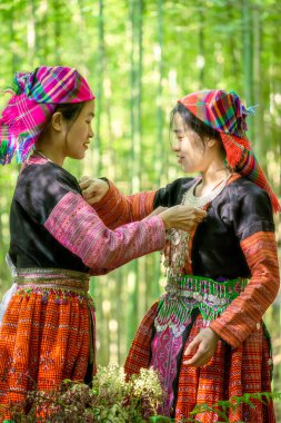 Mu Cang Chai, Yen Bai, Vietnam 'daki bambu ormanlarında gezen renkli kostümlü etnik azınlık insanları. Vietnam bambu ormanları. Ormandaki yüksek ağaçlar. Seçici odak.