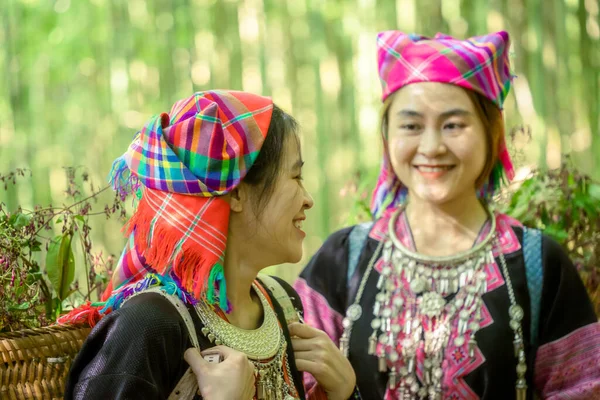 People H\'mong ethnic minority with colorful costume dress walking in bamboo forest in Mu Cang Chai, Yen Bai province, Vietnam. Vietnamese bamboo woods. High trees in the forest. Selective focus.