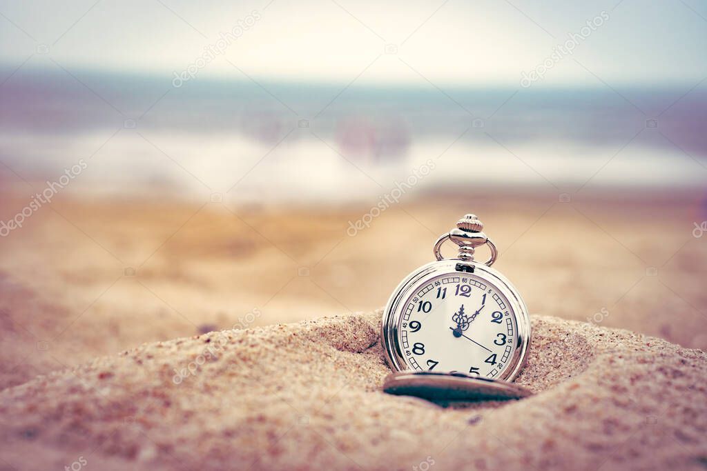 retro pocket watch on the beach