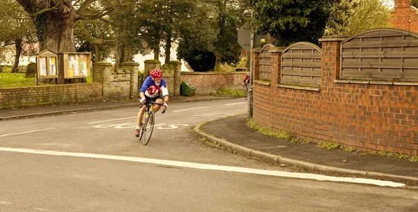 A lone cyclist struggles to catch up with the leaders. — Stock Photo, Image