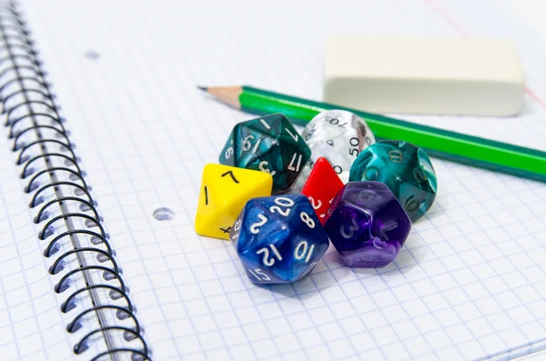 Set of open exercise book, pencil, rubber and dices isolated on — Stock Photo, Image