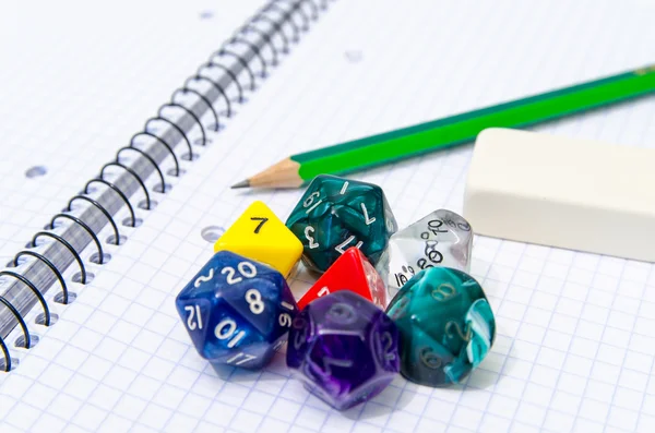 Set of open exercise book, pencil, rubber and dices isolated on — Stock Photo, Image