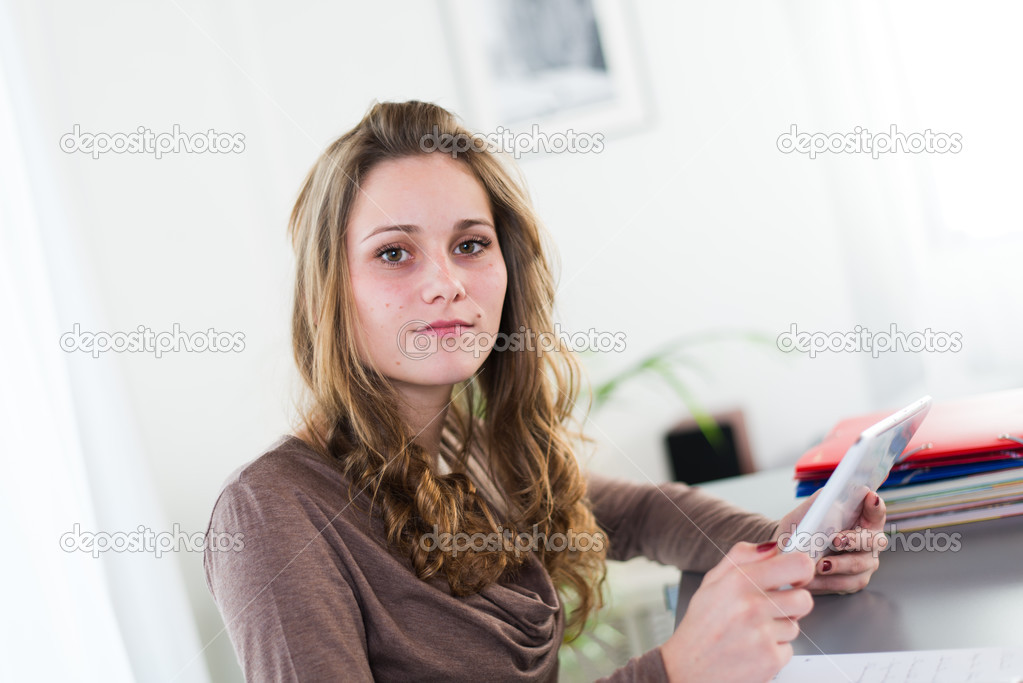 Portrait of a young student doing homework