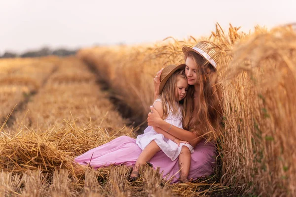 Mother Tenderly Hugs Little Daughter Who Sitting Knees Golden Wheat — Stock Photo, Image