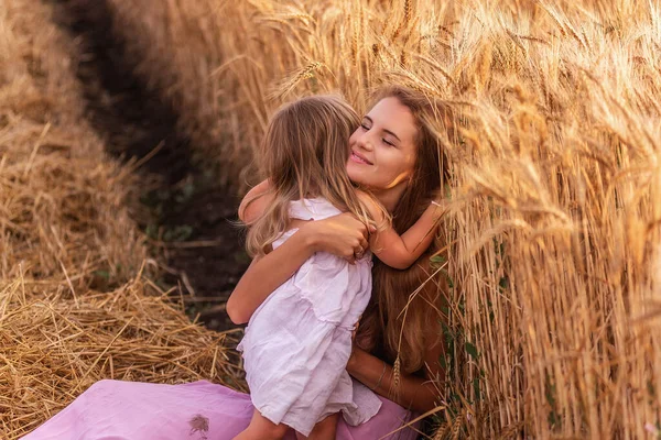 Мать Нежно Обнимает Маленькую Дочь Которая Сидит Коленях Золотого Пшеничного — стоковое фото