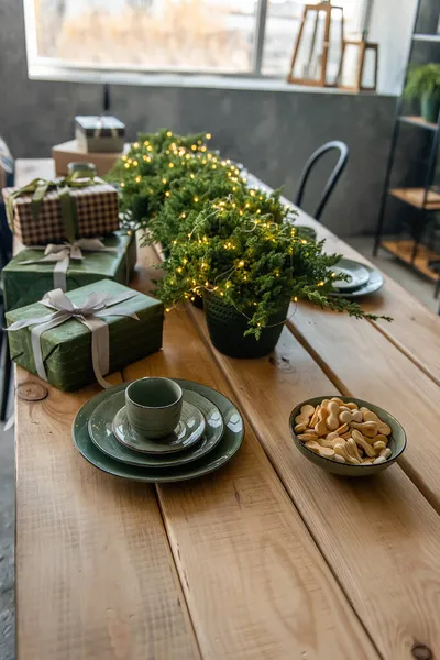 Wooden Table Festive Green Dishes Wrapped Boxes Gifts Thuja Pots — Stock Photo, Image