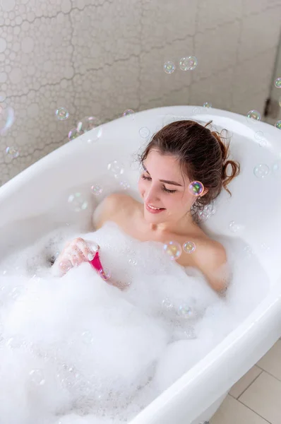 Young Woman Hair Pinned Bun Takes Bath Foam Blows Catches — Stock Photo, Image