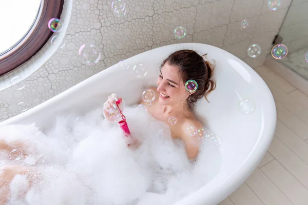 Young Woman Hair Pinned Bun Takes Bath Foam Blows Catches — Stock Photo, Image