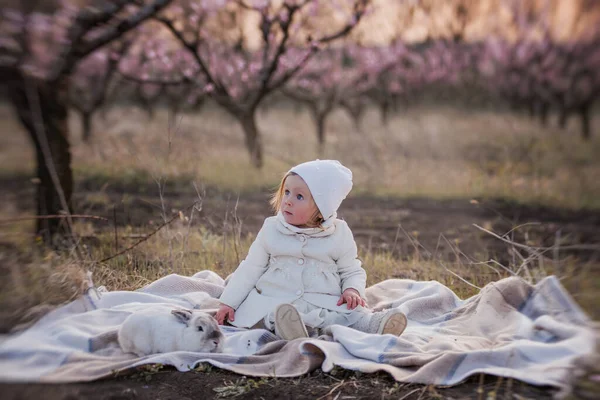 Little Toddler Girl White Coat Hat Plays Domestic Easter Rabbit — Stock Photo, Image