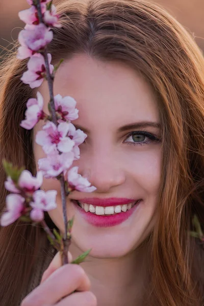 Close Portrait Young Millennial Woman Holding Blooming Pink Sakura Branch — ストック写真