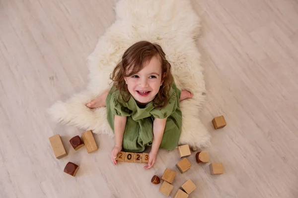 Top View Girl Who Holds Wooden Cubes Numbers 2023 Her — стоковое фото