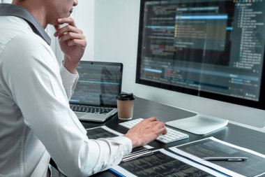 Bilişim ofisinde yazılım javascript bilgisayarı üzerinde çalışan genç programcı, problem çözümü bulmak için kodlar ve veri kodu web sitesi ve kodlama veritabanı teknolojileri yazıyor.