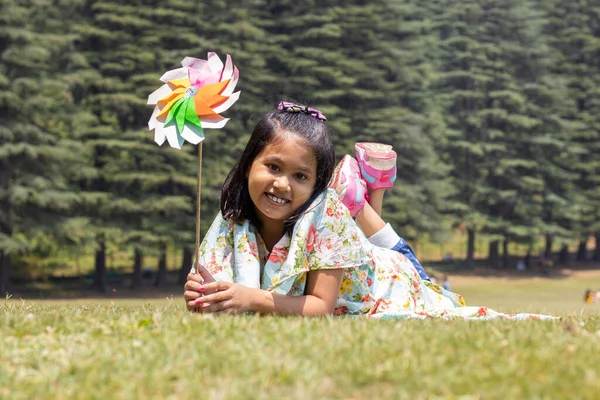 Cheerful Smiling Indian Girl Child Lying Green Grass Field Looks — Stockfoto