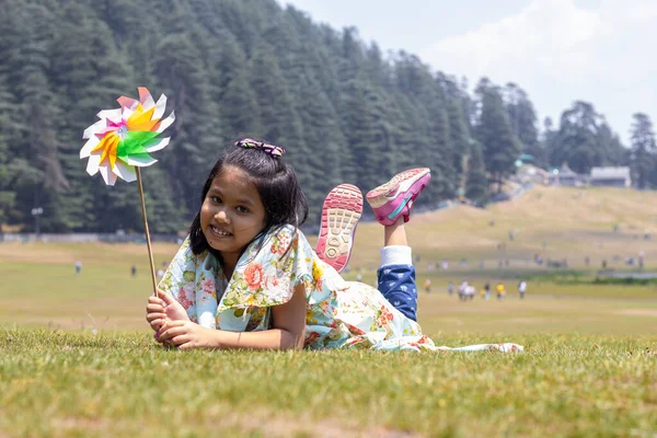Cheerful Smiling Indian Girl Child Lying Green Grass Field Looks — Stockfoto