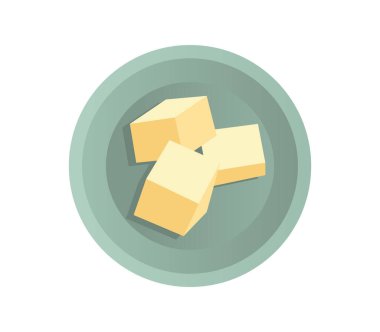 Tereyağı parçaları, beyazın üzerinde izole edilmiş bir fincan tabağının üzerinde yatıyor. Üst görünüm.