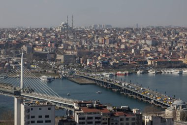 View from the Galata Tower to the western part of Istanbul, Golden Horn Strait, Eminonu district. Galata Bridge, Ataturk Bridge, filled with urban transport, various houses and mosques are visible