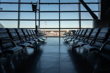 Several rows of seats in the airport's international terminal are completely empty. There are no passengers at the airport . No people at the airport during the covid 19 coronavirus pandemic.