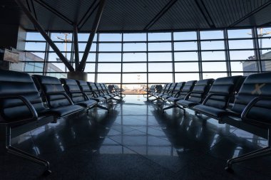 Several rows of seats in the airport's international terminal are completely empty. There are no passengers at the airport . No people at the airport during the covid 19 coronavirus pandemic.