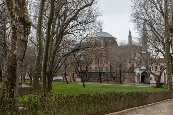 Hagia Sophia is located at the Sultanahmet square. It has high minarets and few large domes. The cathedral is made of red stone and is very large in size. Cloudy day in Istanbul.