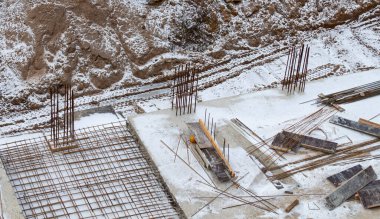construction of a foundation from a concrete monolith in snowy weather. Construction concept