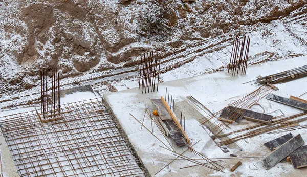construction of a foundation from a concrete monolith in snowy weather. Construction concept