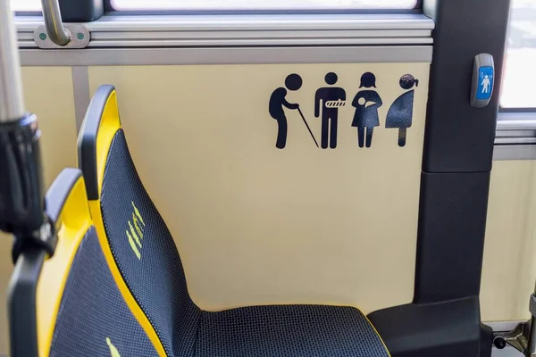 Empty seats on the bus, reserved for the elderly and people with mobility difficulties.