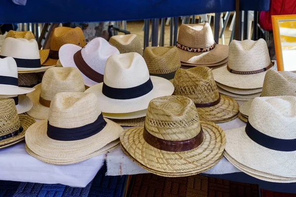 Panama style straw hats for sale at a summer market. Protection from the sun on hot days.