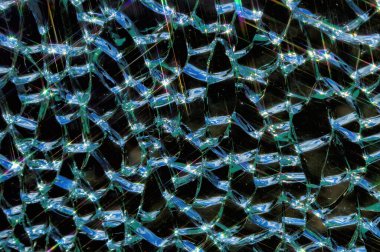 broken tempered glass texture background with sun bunnies and star rays close up