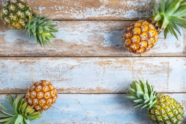 Pineapple fruit on a wooden background