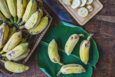Fresh bananas in a basket on a wooden table