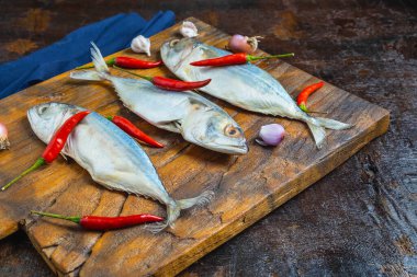 Mackerel Fish On Wooden Chopping Board