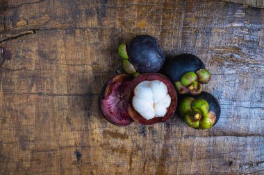 Fresh mangosteen fruit on a wooden table
