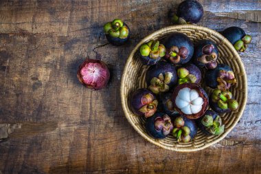 Fresh mangosteen fruit in a basket on the table