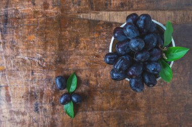 Black grapes in a basket on a wooden table