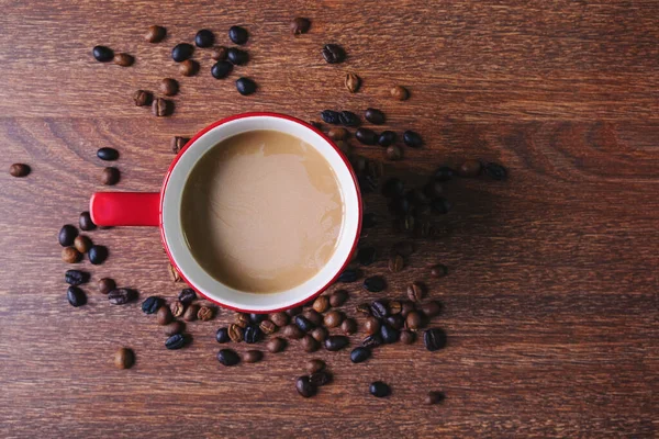 stock image Coffee in a red coffee cup on a wooden table